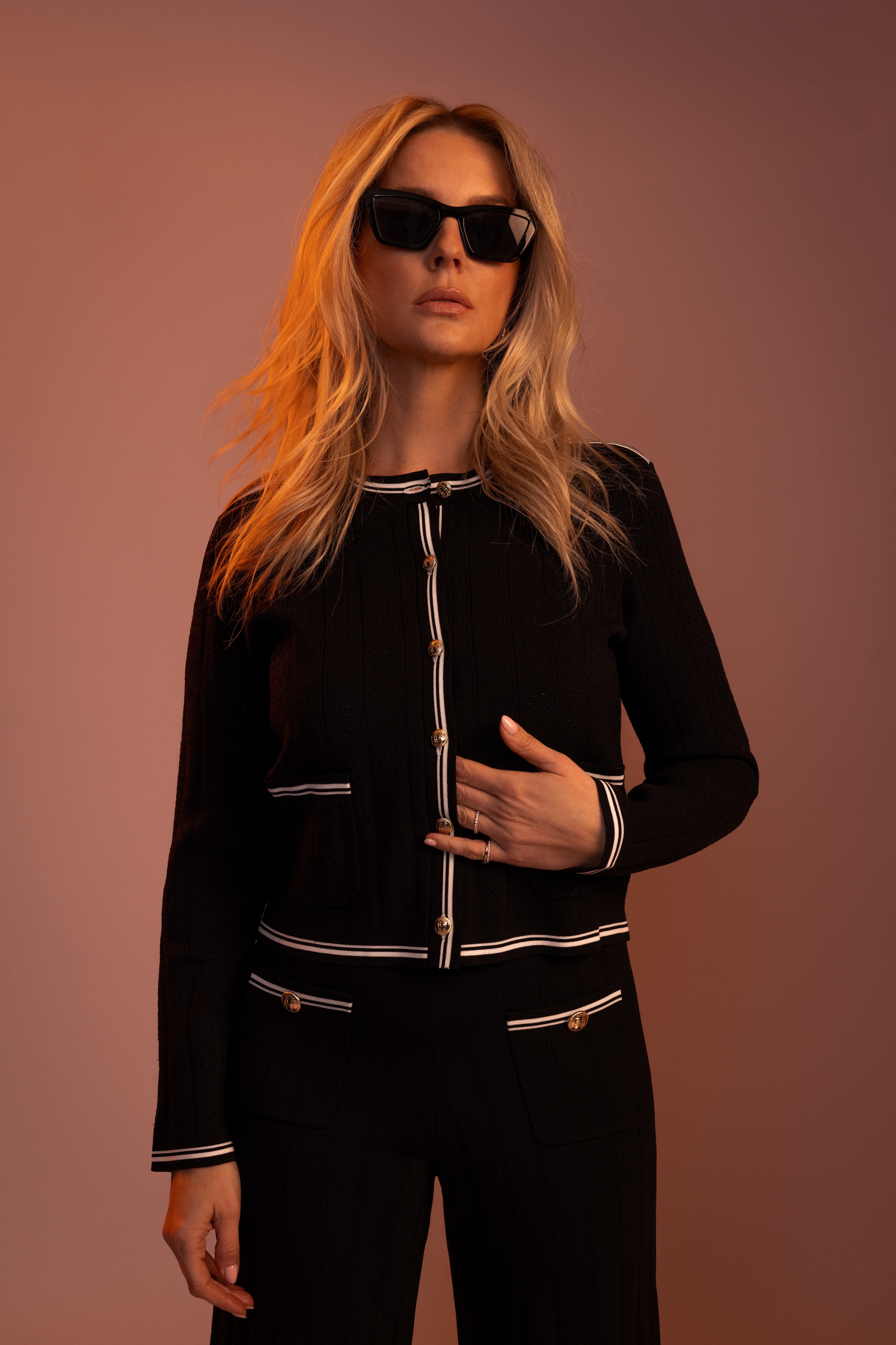 Fitted cardigan with open knitted pattern and white piping