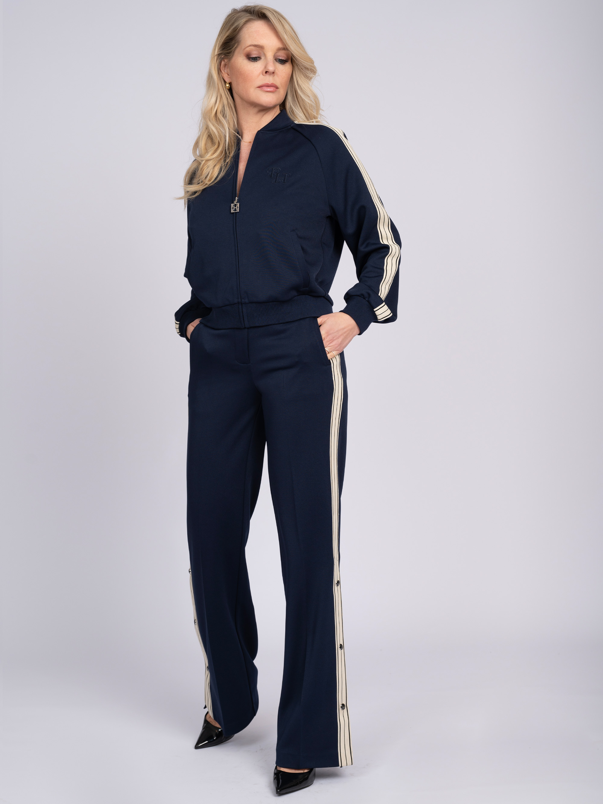Pants with stripes and buttons on the side