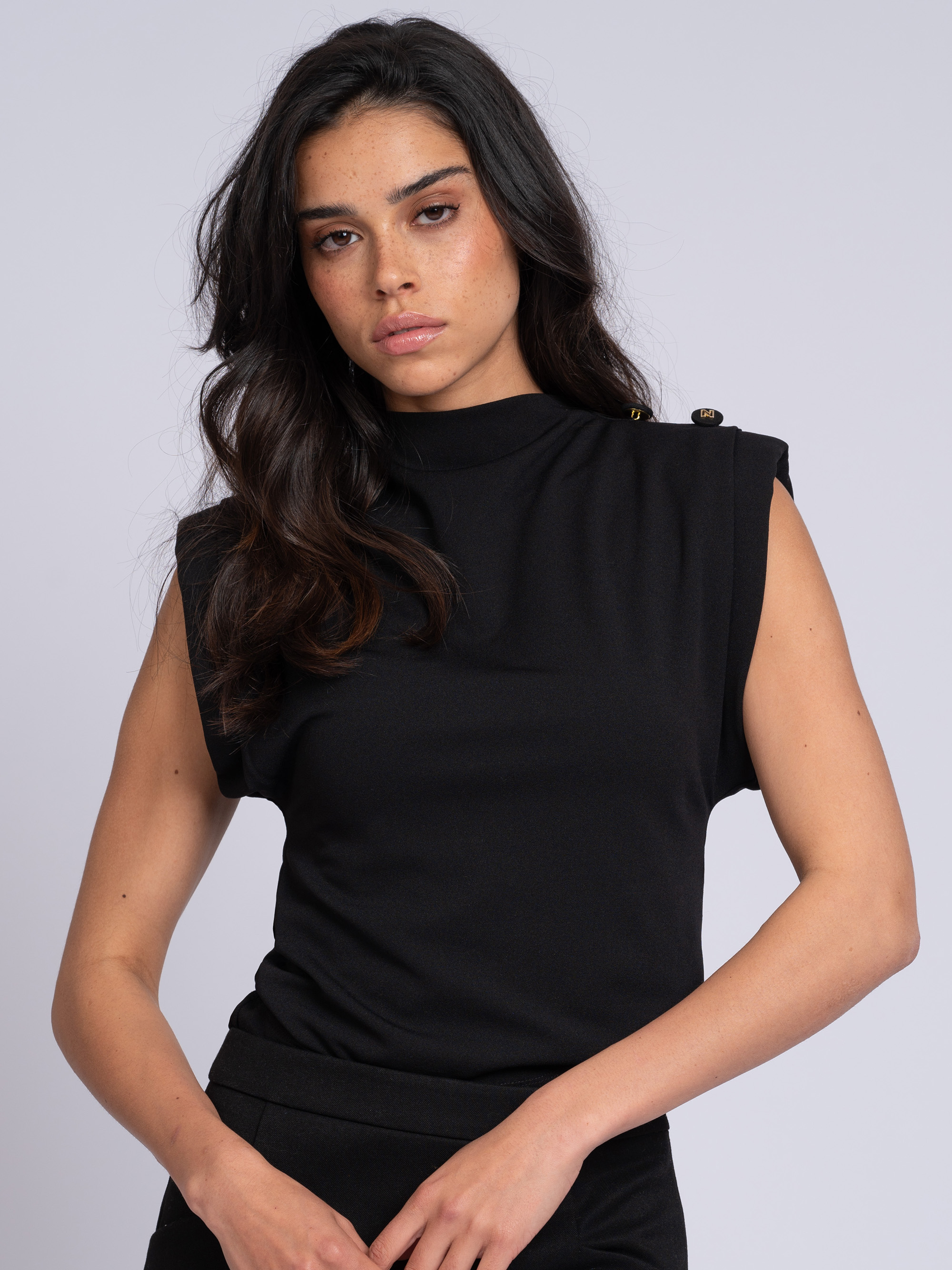 Fitted top with wide shoulders and high neck